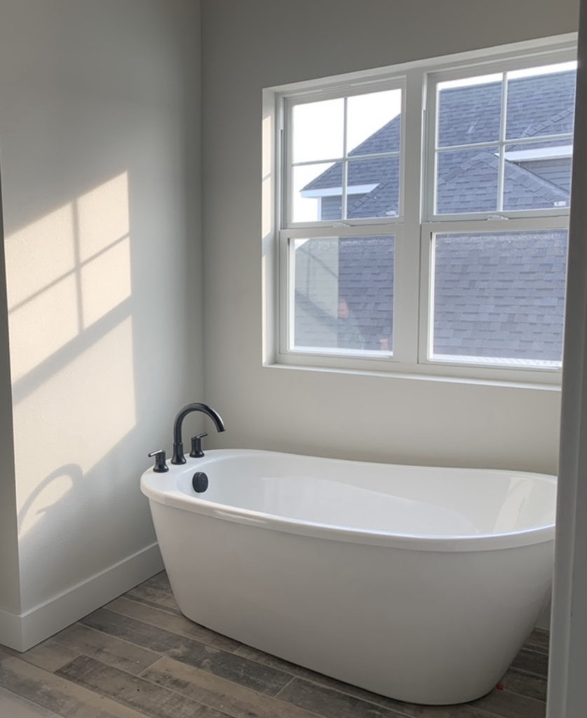 Bathtub in a bathroom alcove.