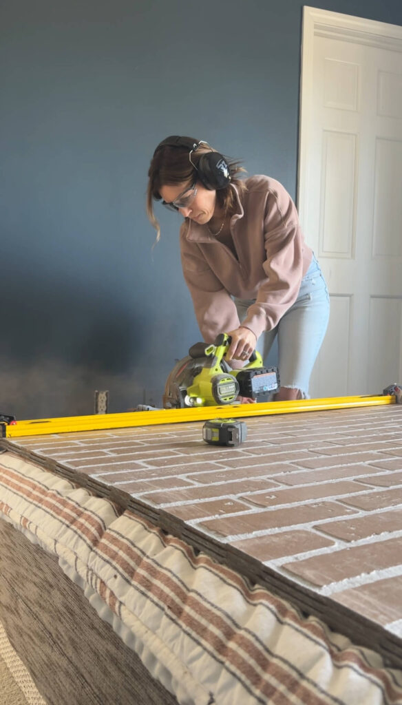 Melissa, from Lake and Lumber, using her saw to cut the brick panels for it to be even. lakeandlumber.com 