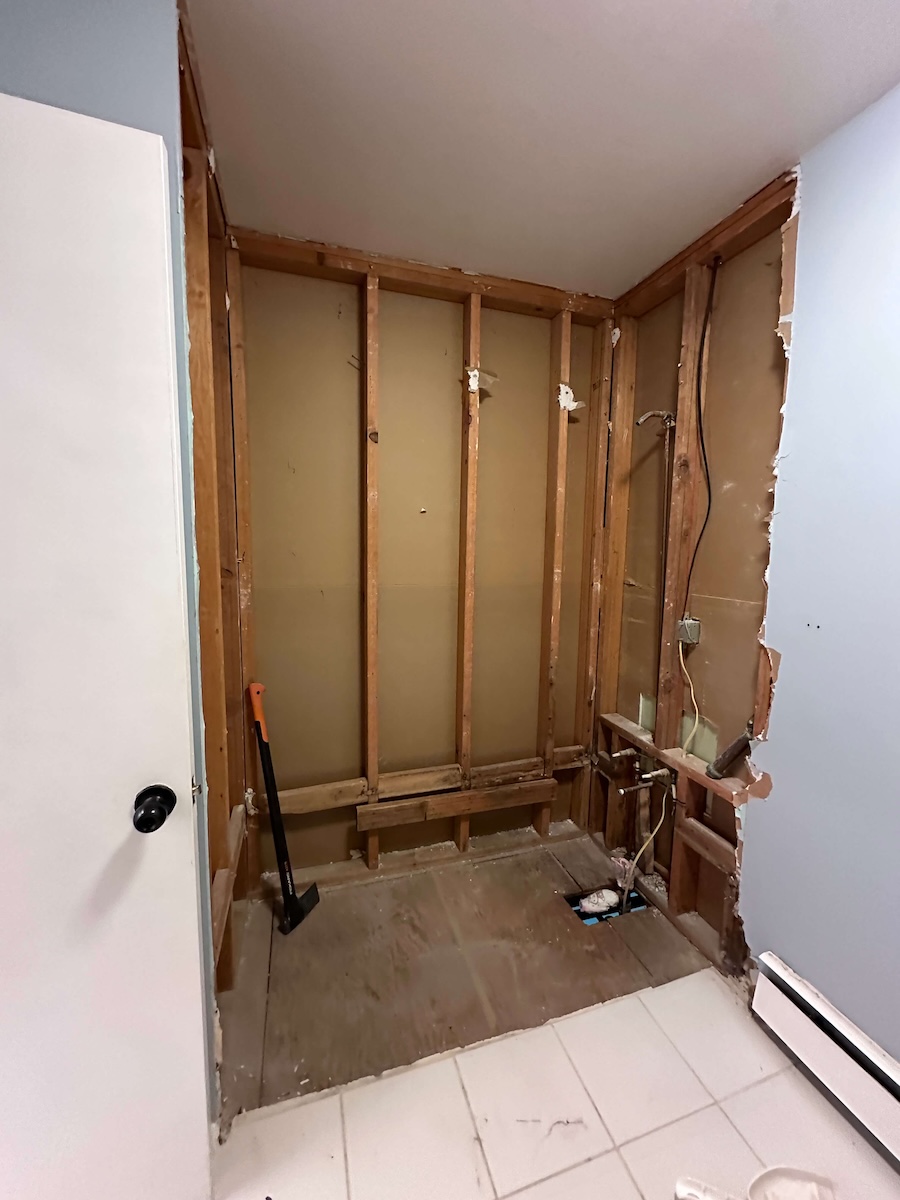 All the plumbing of the shower revealed. The shower completely stripped down to studs and ready for the bathroom DIY renovation. 