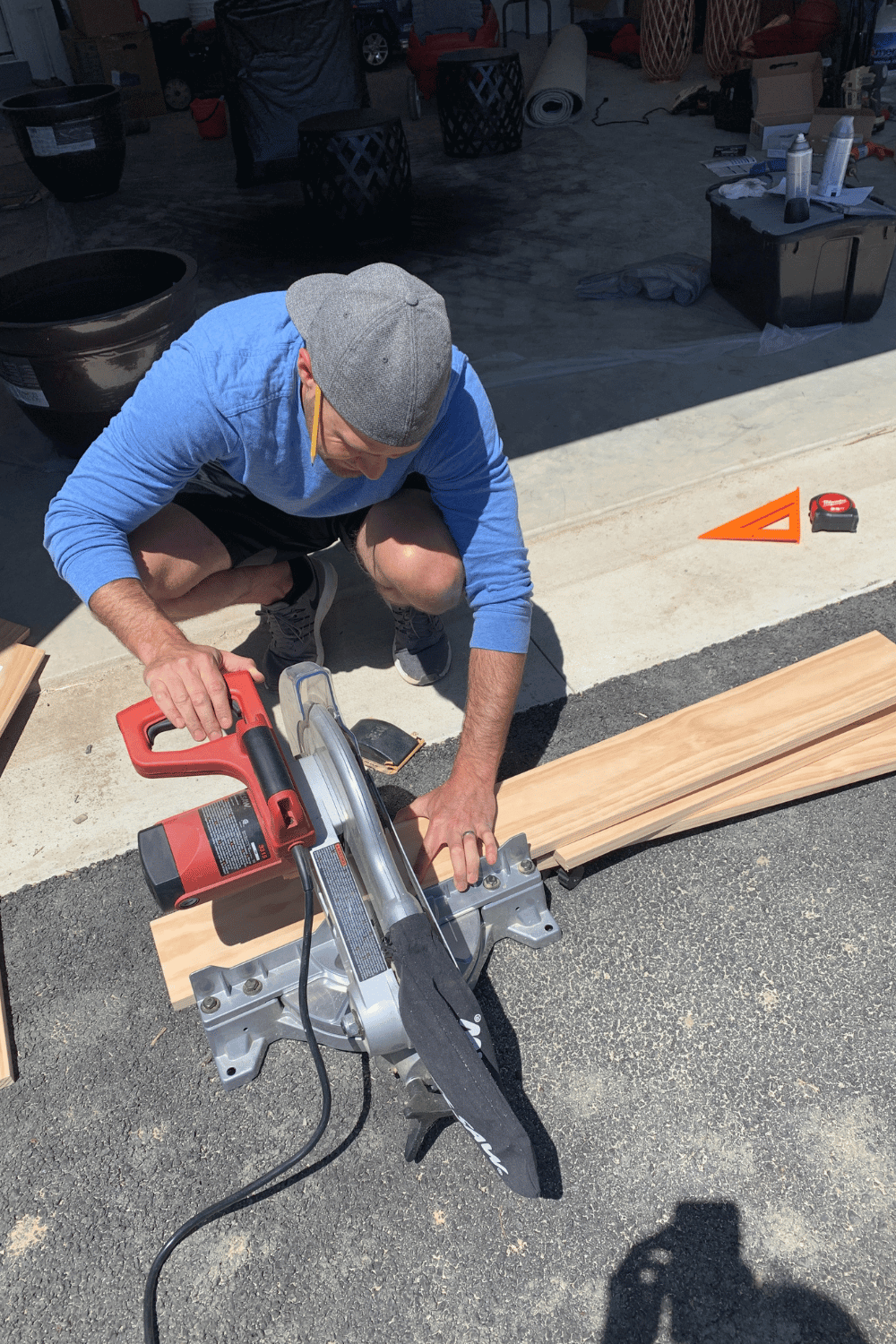 Cory cutting project wood with a saw.