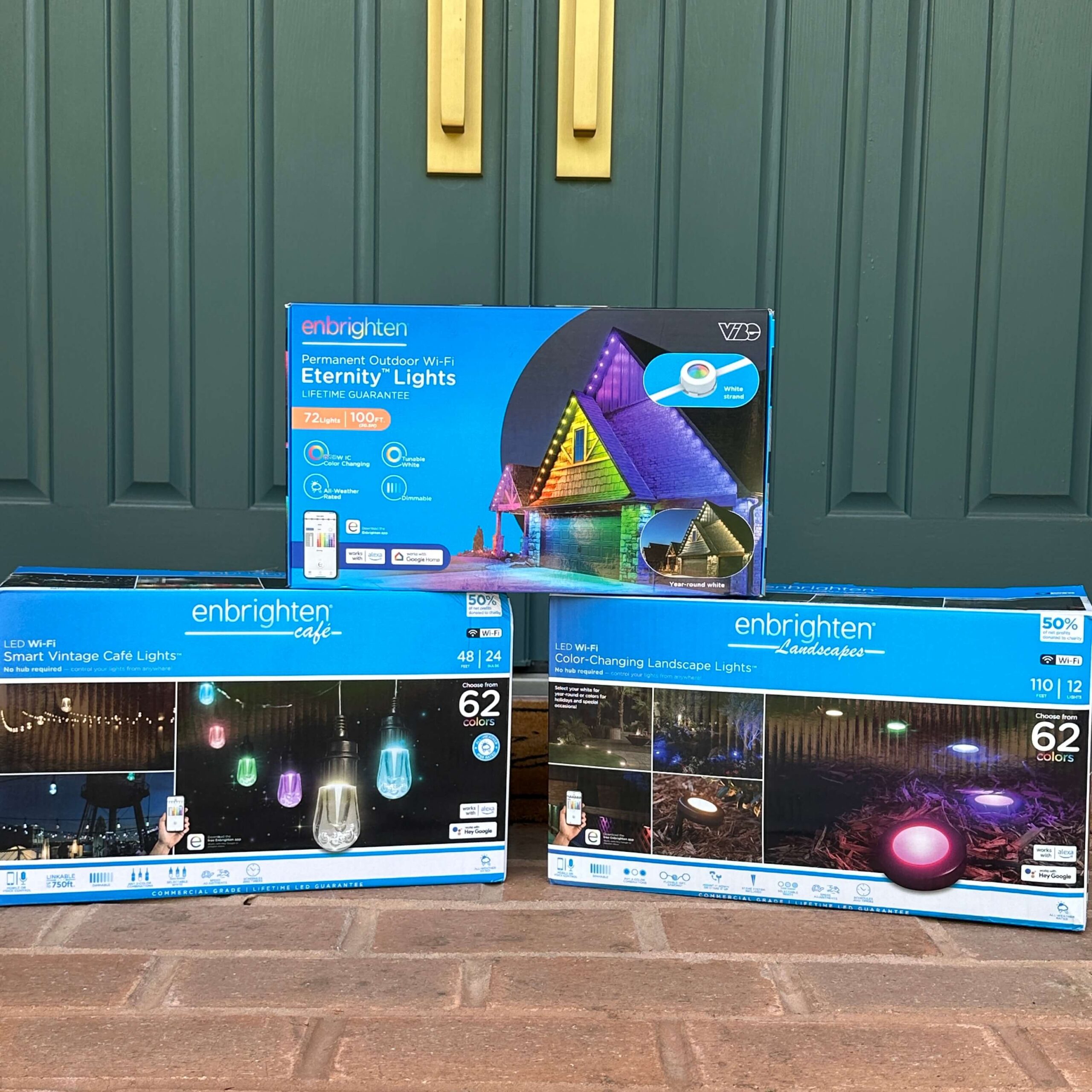 Three boxes of Enbrighten outdoor lighting - Eternity Lights, Cafe Lights, and Landscape Lights.