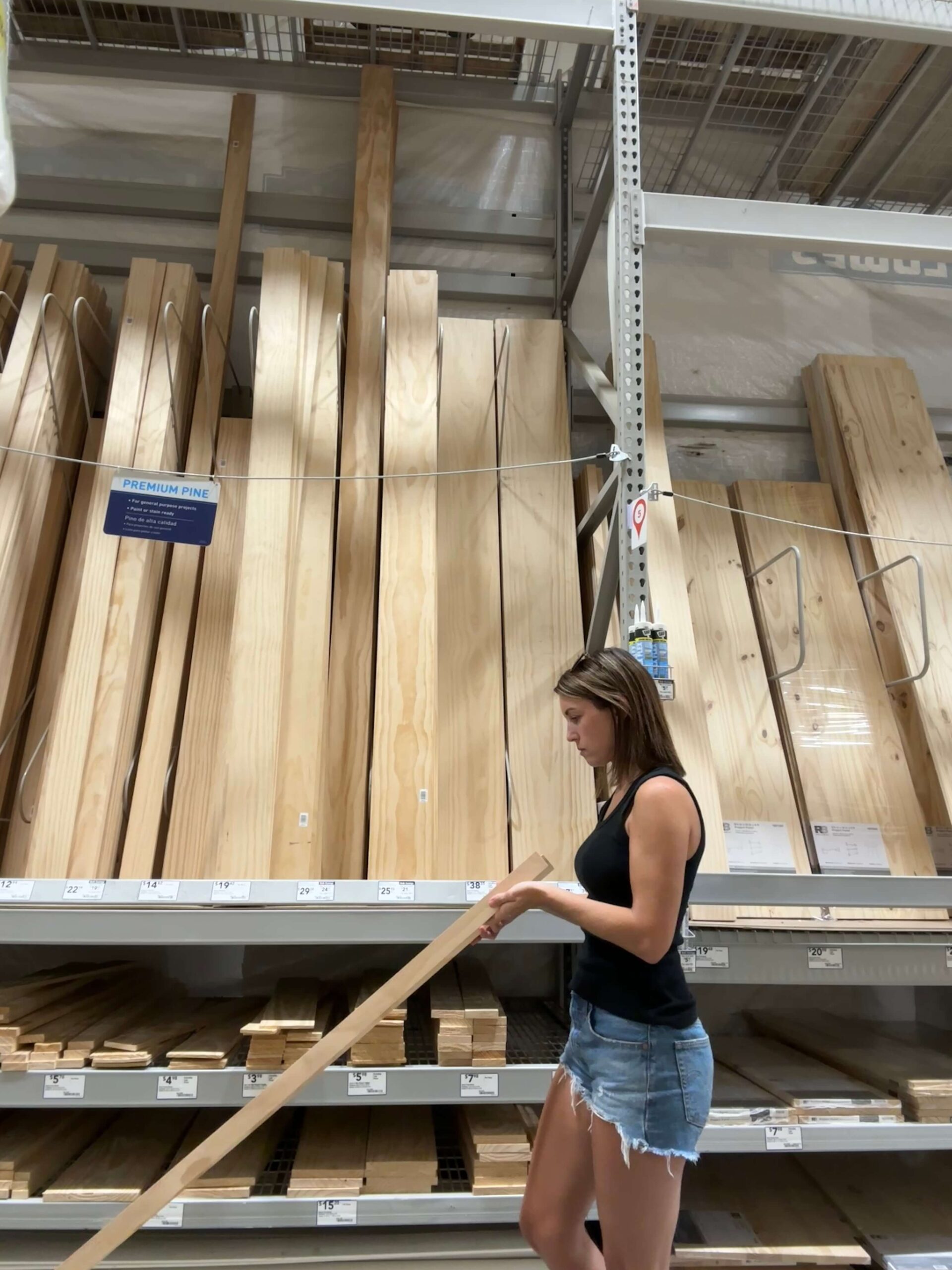 Melissa Tyler selecting project wood at a hardware store.
