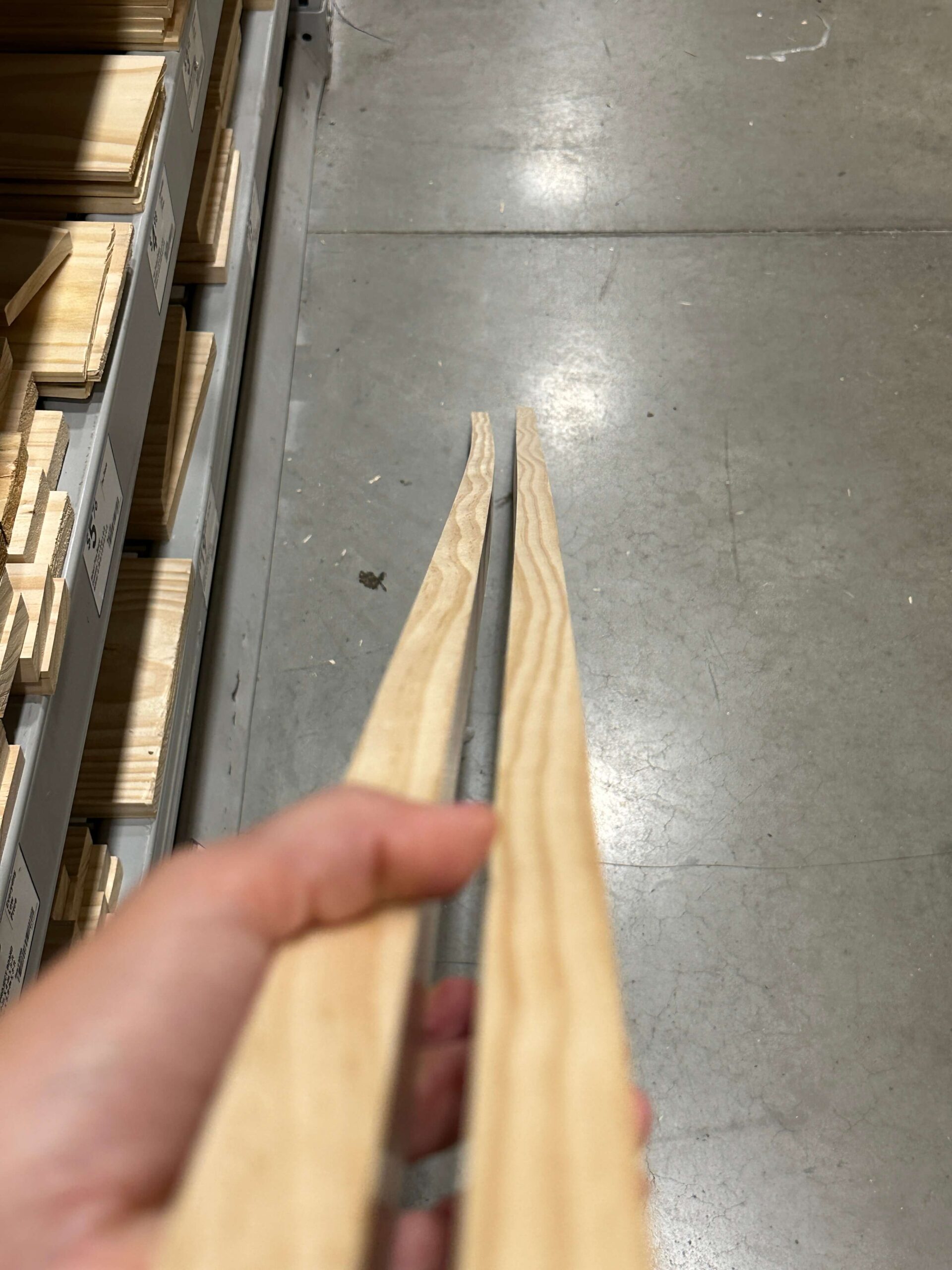 Two long boards of project wood side-by-side. One piece of wood is straight, and the other is skewed to the left. 