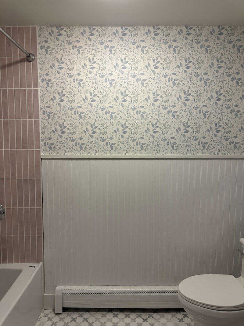 Completed wallpaper installation on bathroom walls.