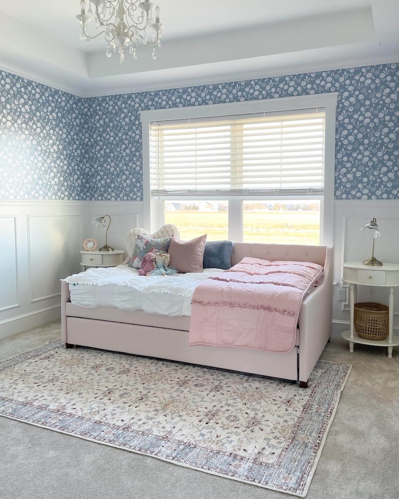 Blue wallpaper hung in a child's bedroom.