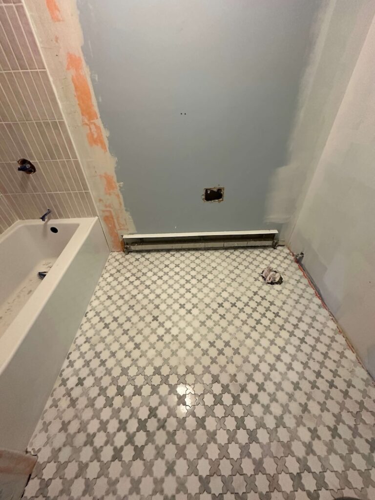 Tile flooring laid above Schluter Ditra membrane.