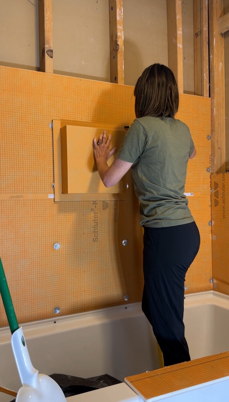 Melissa Tyler installing the Kerdi Systems one-ledge shower niche. 