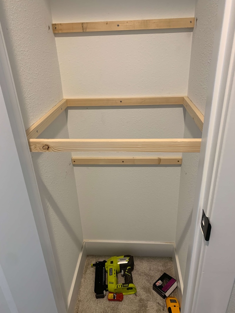 Closet shelf braces in a closet.