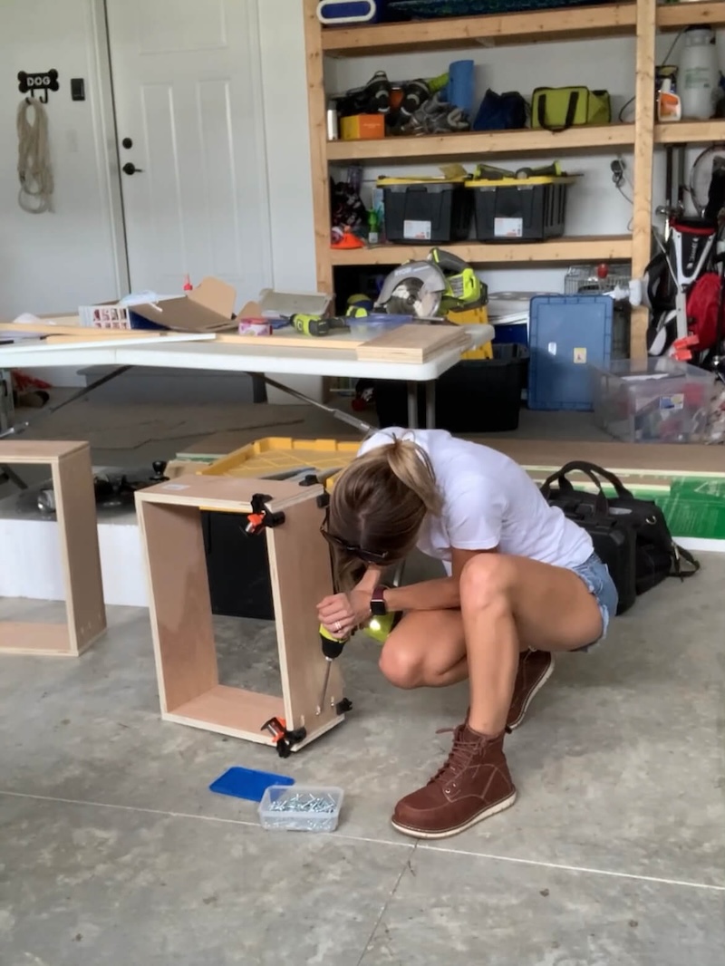 Melissa Tyler assembling the DIY closet tower and shelves in her garage. 