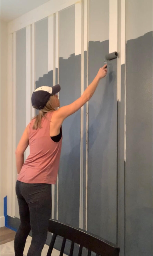 Melissa Tyler painting the DIY accent wall. 