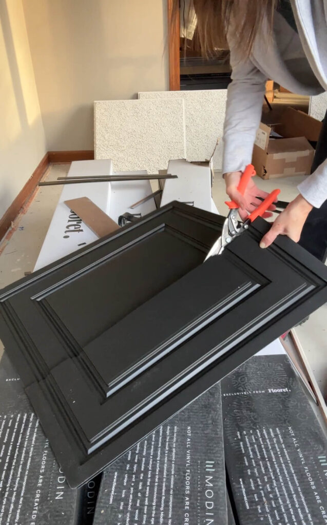 Melissa Tyler cutting a tile to size for her project.